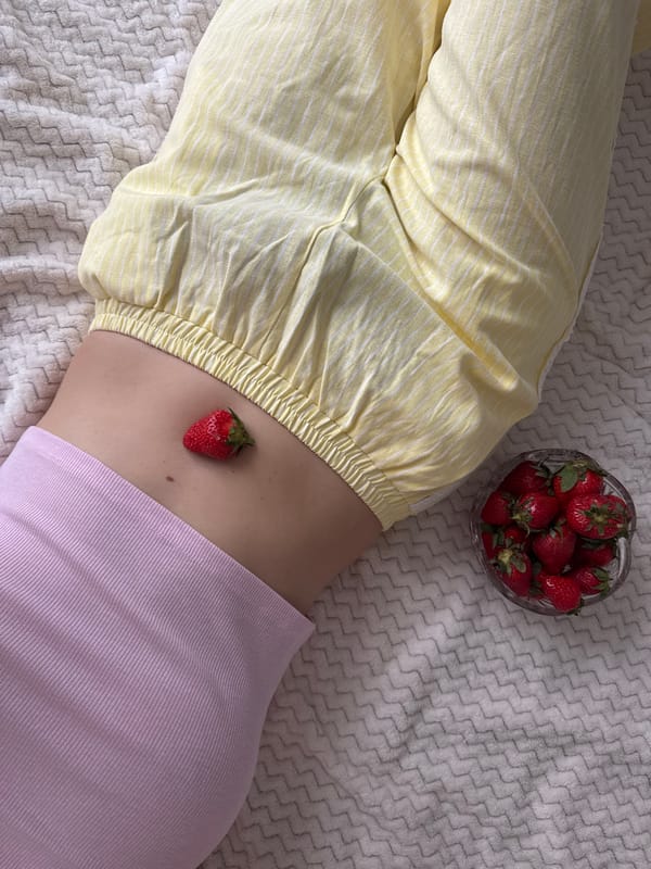 Person enjoys outdoor reading session with strawberries in Izhevsk