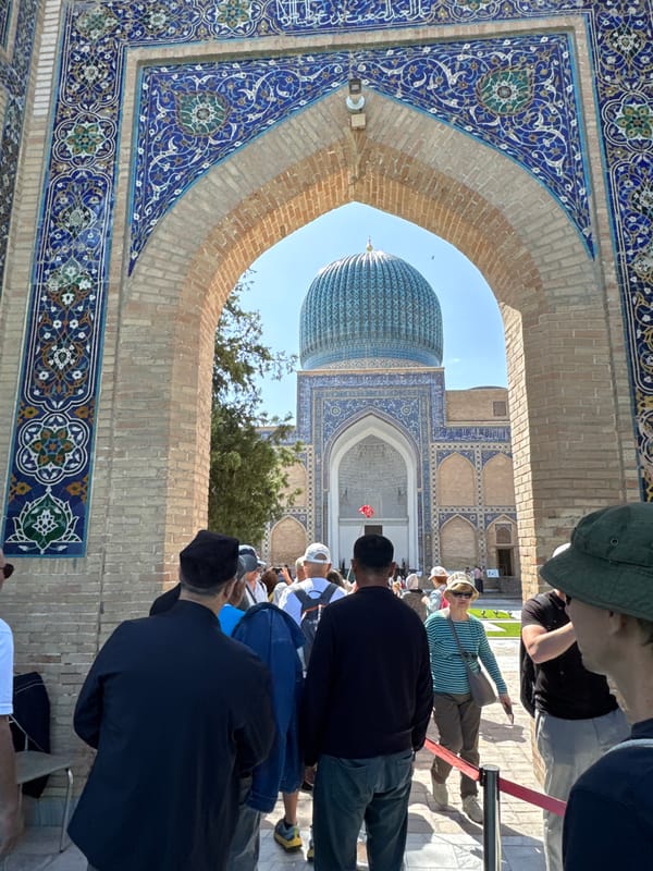 Tourists photograph historic Gur-e-Amir mausoleum in Samarkand