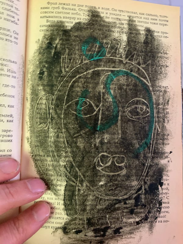 Russian book pages defaced with drawings, charcoal, and photos