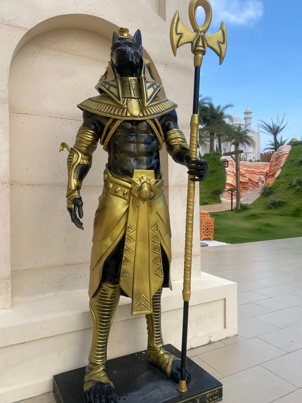 Tourist women photographed near Egyptian Anubis statue in Vietnam
