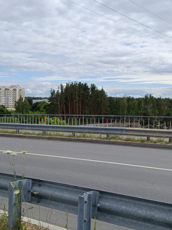 Overcast afternoon in Svietlahorsk: roads, rail yards, and Soviet-era suburbs