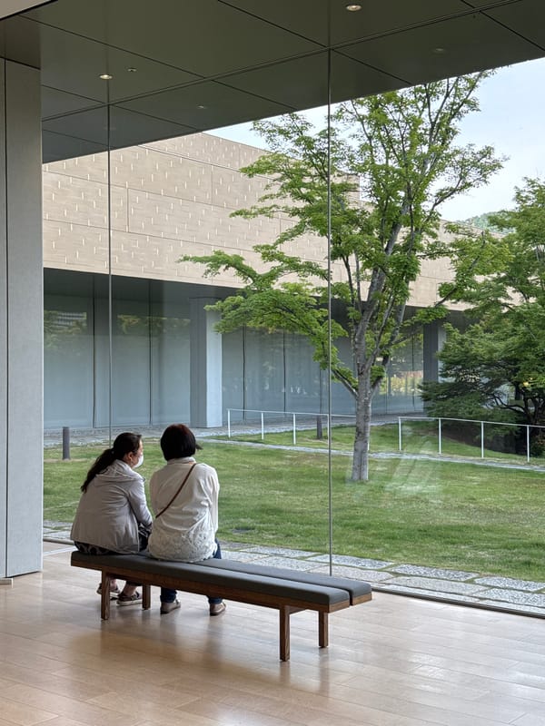 Morning visitors rest on benches around Kyoto gardens