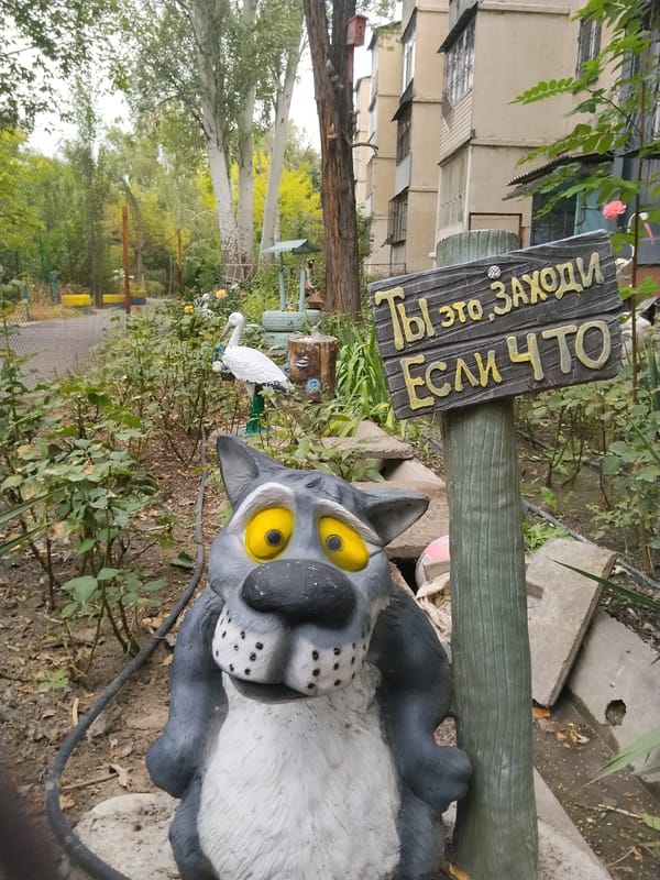 Casual snapshots around a Bishkek yard, including a wolf statue and daily life