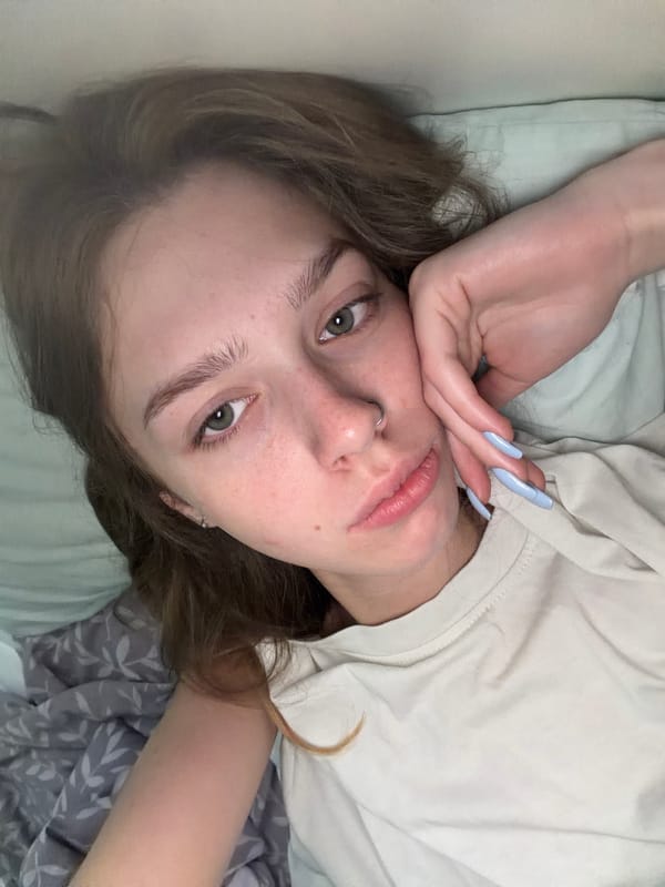 Quiet morning in bed with a cat and blue flowers