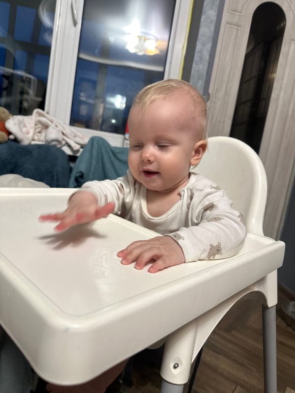Russian parent makes dumplings while tending baby in Pokrov