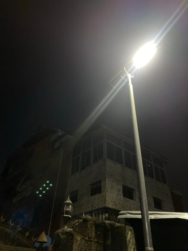 Street lamp illuminates building in Lagos at night