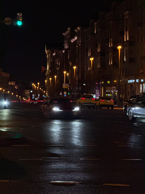 Moscow evening scenes show wet streets, classical architecture, holiday lights