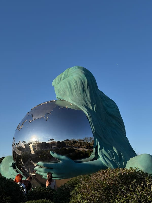 Krasnodar monument featuring woman holding globe photographed by visitors