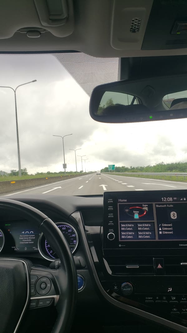 Driver documents highway journey through vehicle interior in Georgia