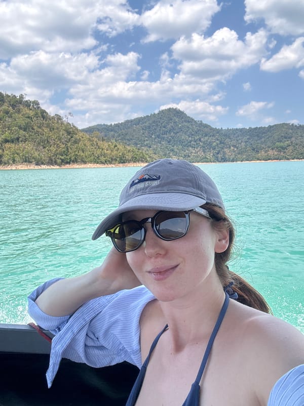 Woman takes selfie while boating on Thailand's Cheow Lan Lake