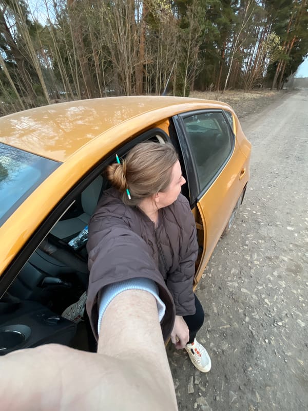 Woman rests in parked car along Russian roadside