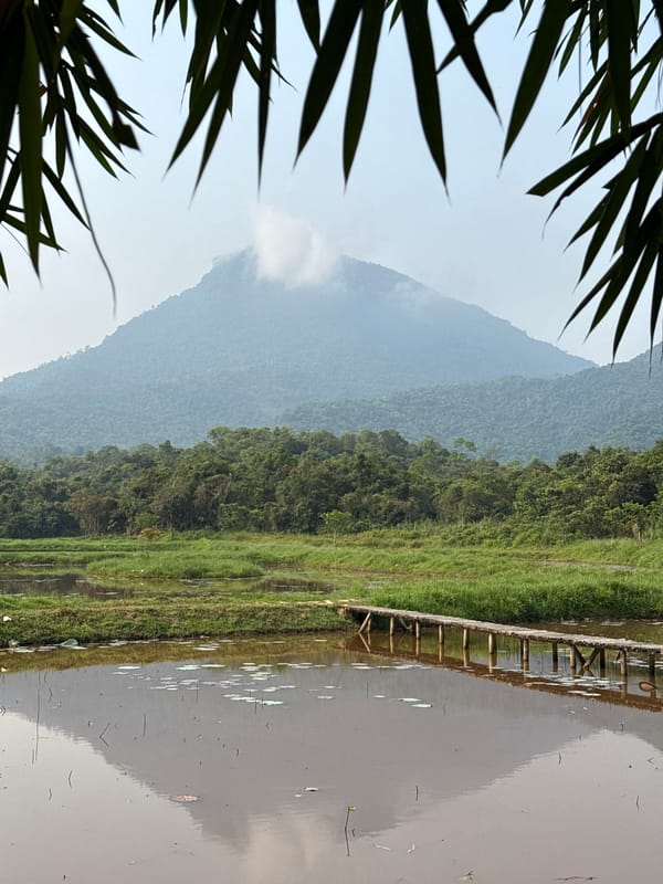 Cloudy mountain landscape reflected in water near Đà Nẵng