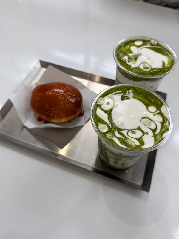 Matcha lattes and donut served on tray in Los Angeles