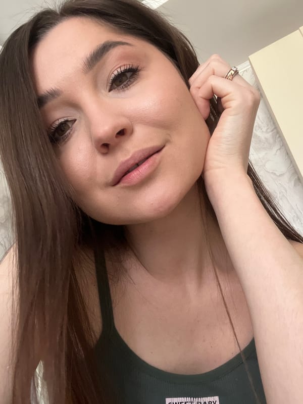 Woman in green tank top poses for camera