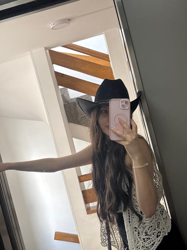 Woman takes mirror selfie in Medellín building interior