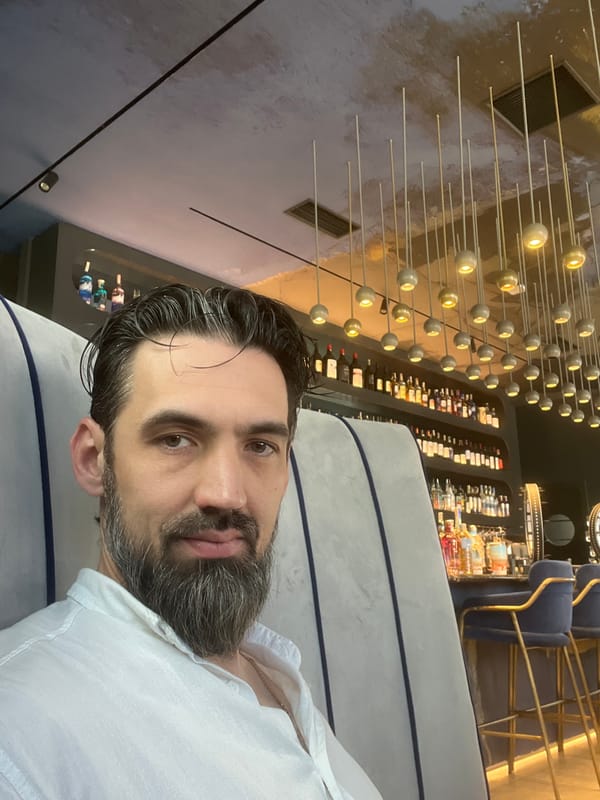 Seated in a striped armchair inside a Tiraspol bar