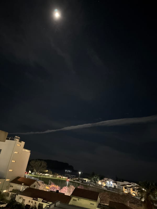 Bright moon and dramatic clouds illuminate Budva night sky