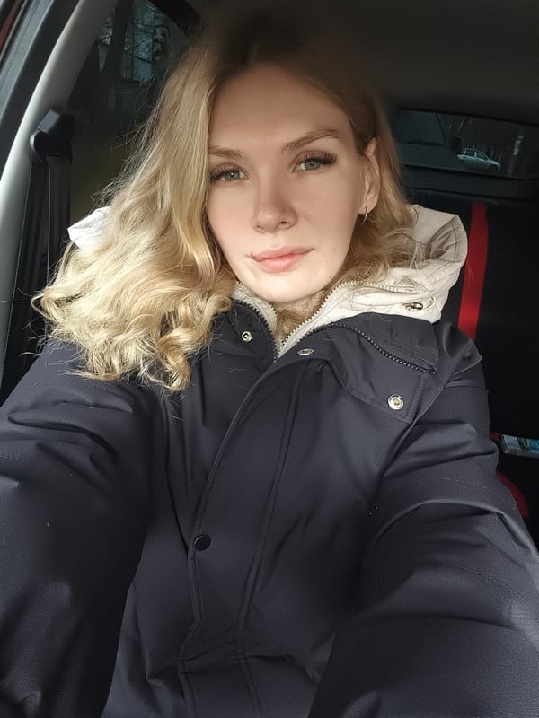 Woman photographed in car, outdoors in Izhevsk early morning