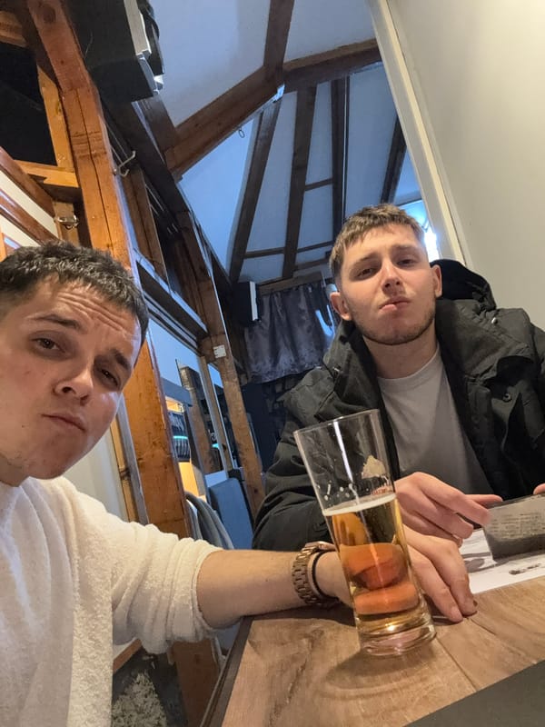 Two men share beers at Kostinbrod bar gathering