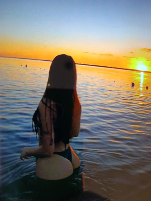 Woman enjoys summer day swimming and sunbathing in Brovary