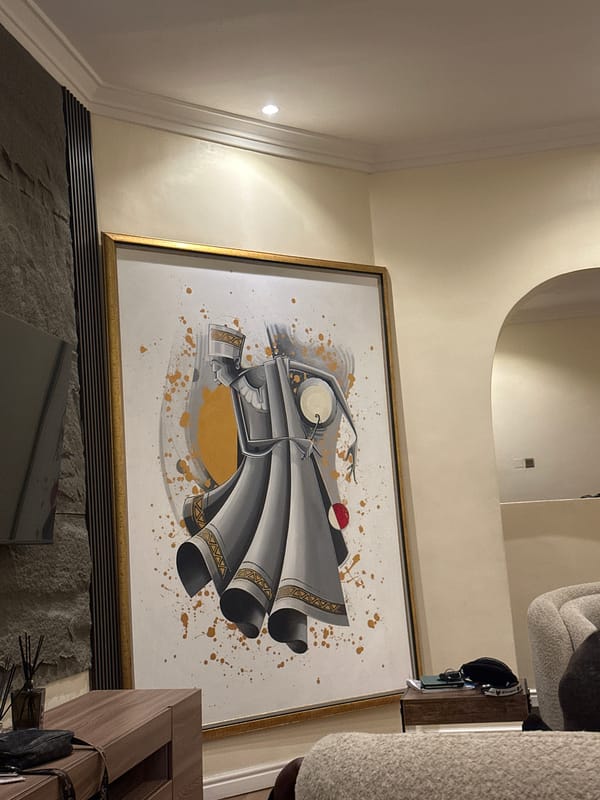 Framed artwork with gold accents observed on yellow wall