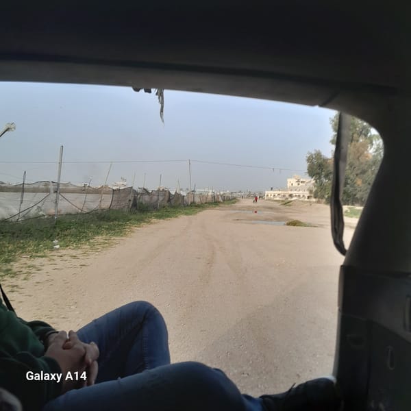 Vehicle passenger photographs street scene in Khan Yunis