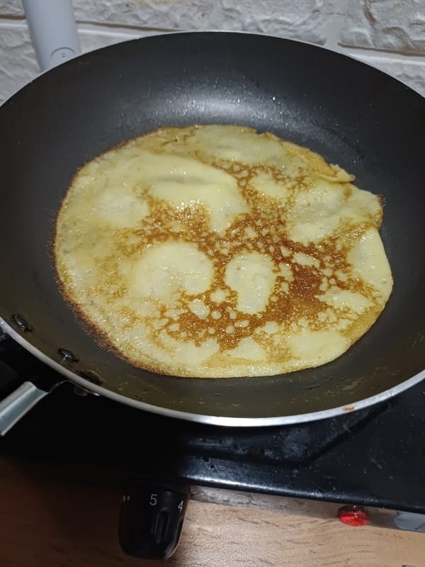 Homemade crepes cooking on a Sochi kitchen stovetop