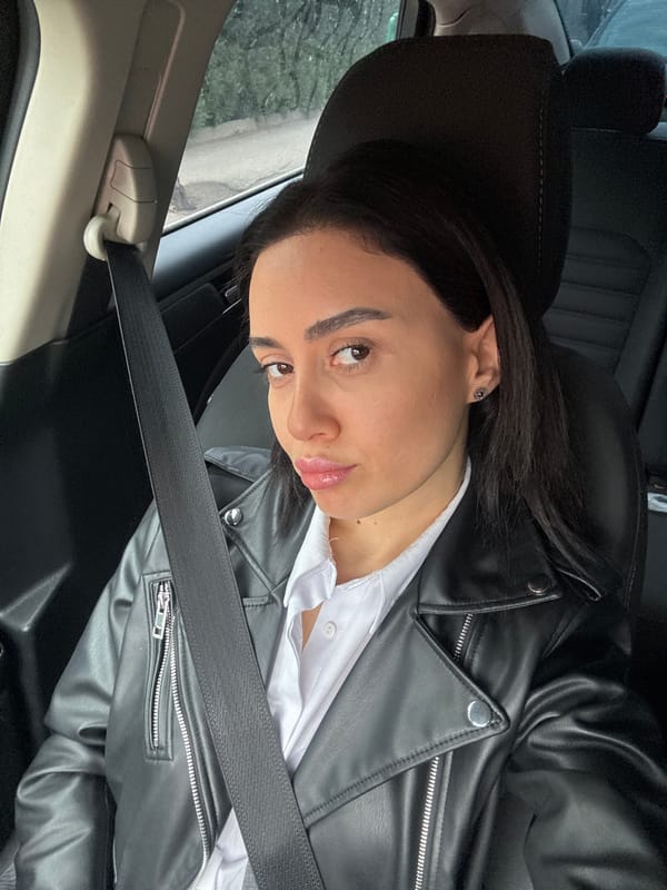 Woman photographed in car making peace signs in Tbilisi