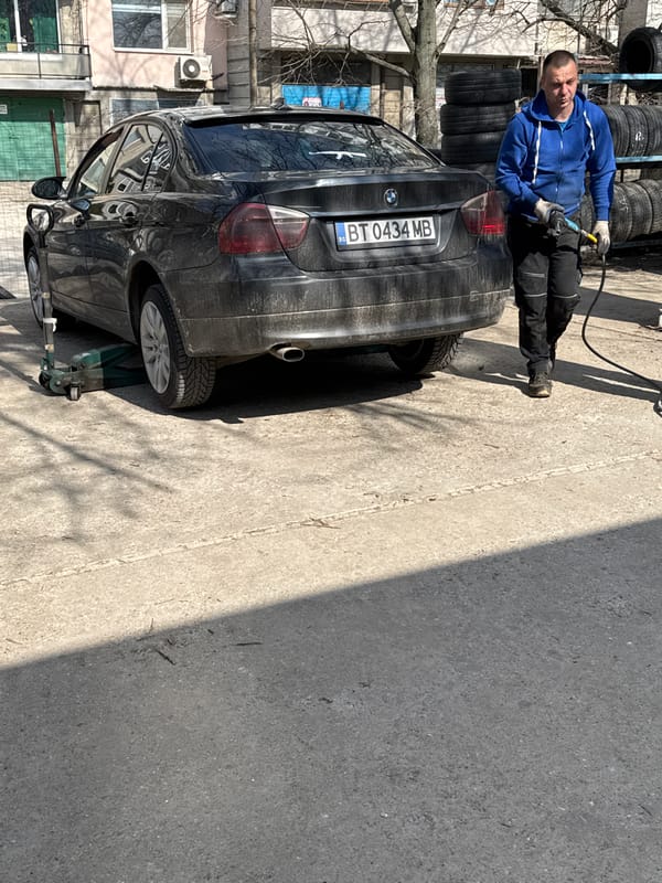 Man inflates BMW tire in Ruse, Bulgaria