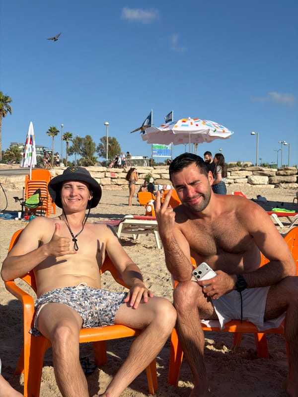 Afternoon beach scene in Tel Aviv with crowds and activities