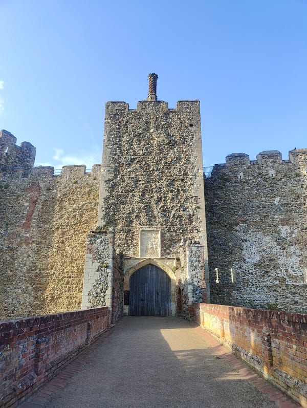 Visitors explore Framlingham Castle grounds during evening hours