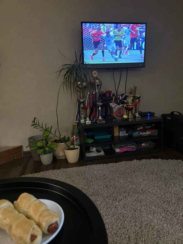 Football on TV, sushi on the table, evening in.