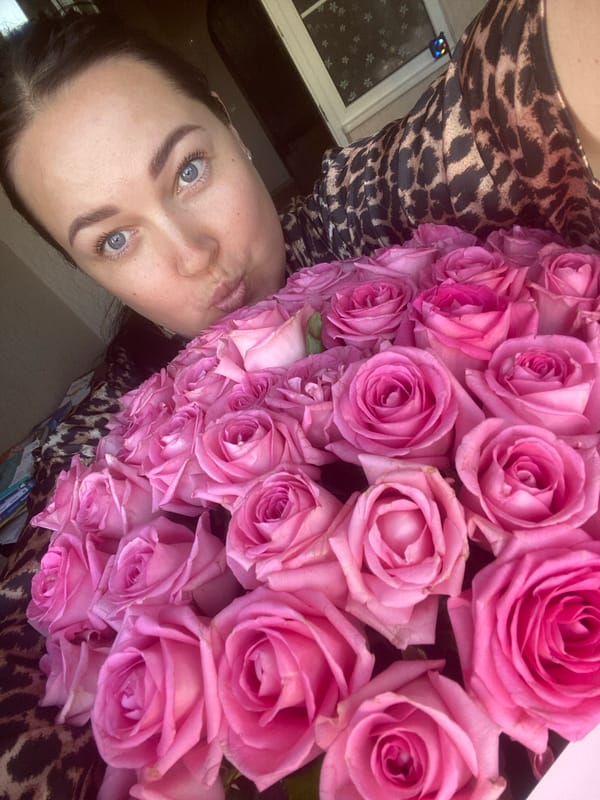Mother and child share pink roses in Sochi home