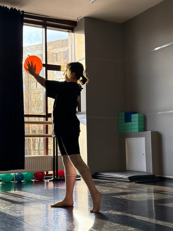 Woman exercises with orange ball in Saint Petersburg studio