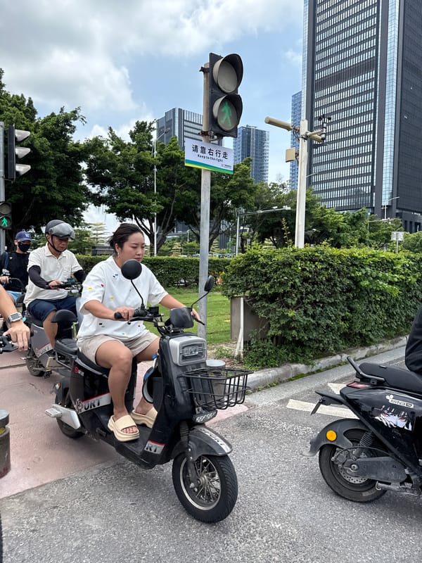 Haizhu District intersection buzzing with scooters and delivery traffic