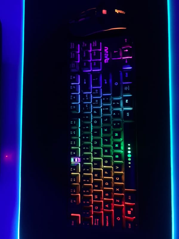 Gaming setup with illuminated mechanical keyboard observed in Lagos