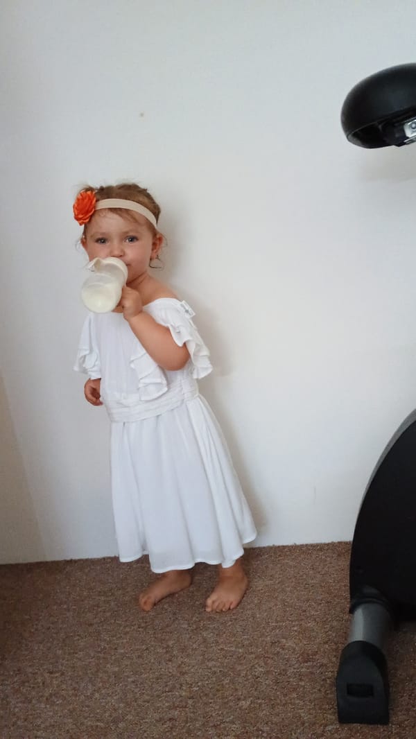 Toddler explores apartment and plays around exercise bike in Sokolov