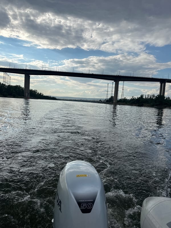 Boat ride and cafe stop with books, bridge, and stormy skies