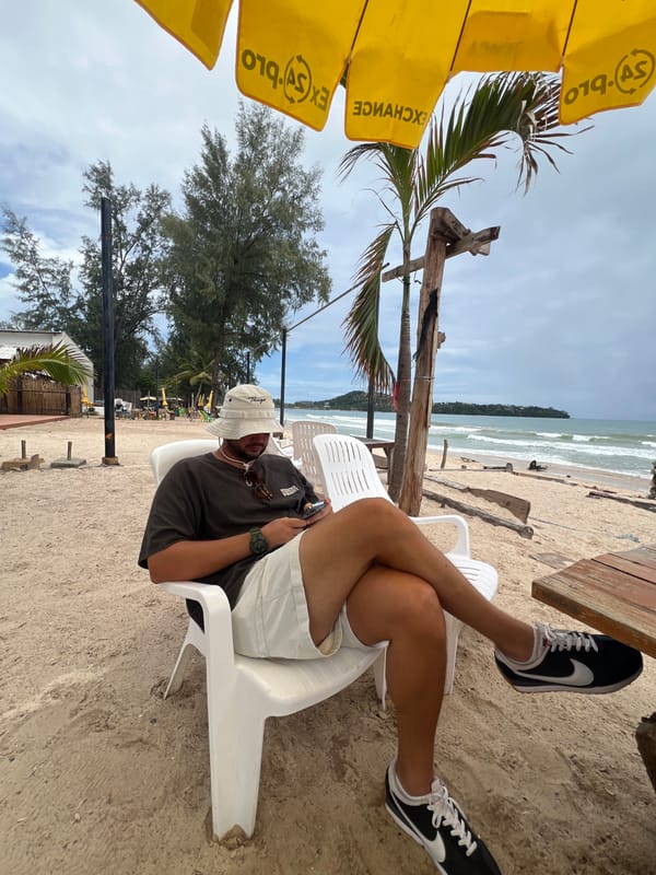 Overcast morning on Choeng Thale beach with vendor and beachgoers