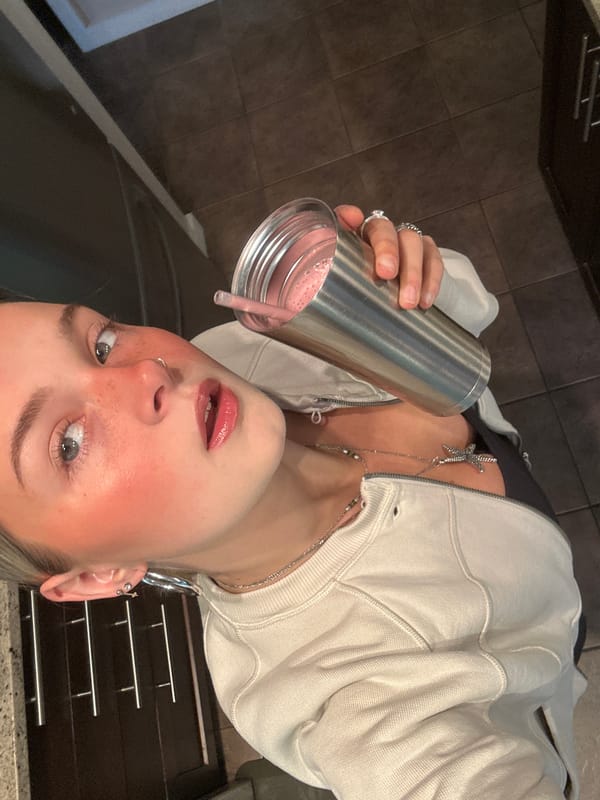 Young woman photographed with pink drink in Whistler kitchen