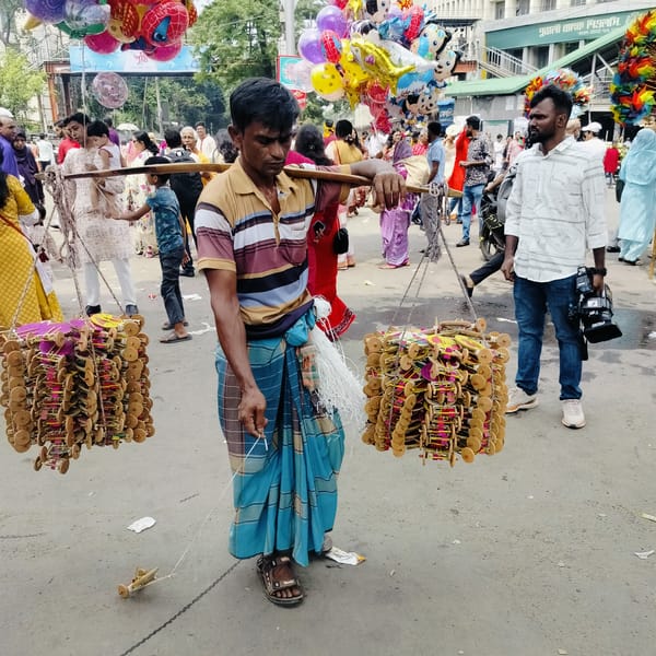 Traditional street market bustles during cultural celebration in Dhaka