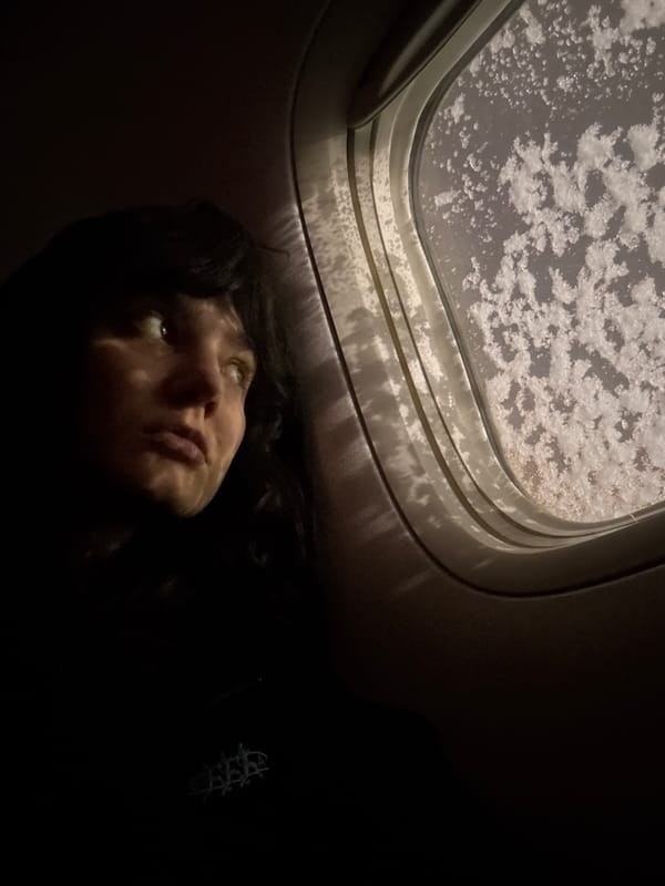 Passenger observes frosted airplane window during flight over Russia