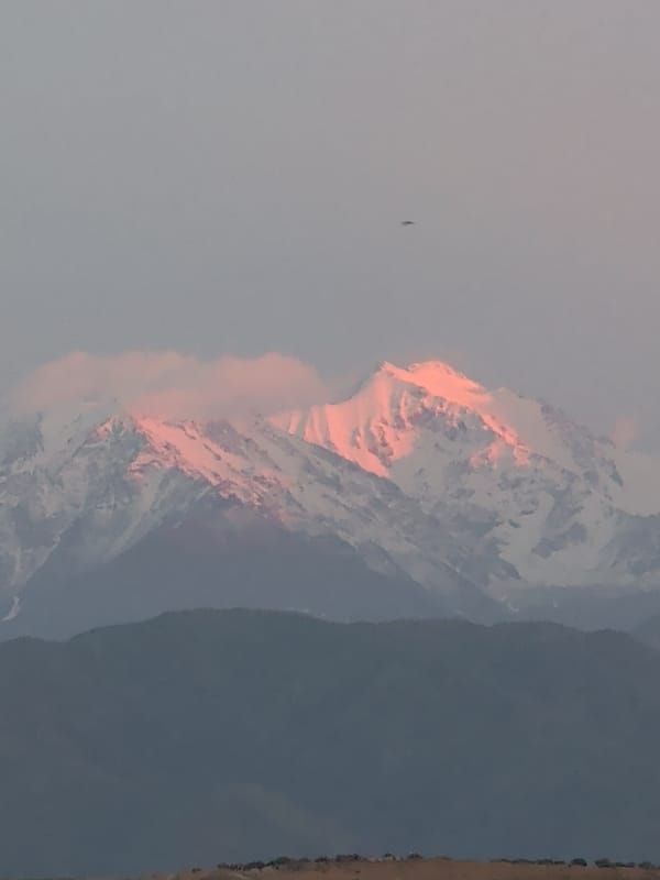 Snow-capped Tian Shan peaks glow at sunset near Bishkek