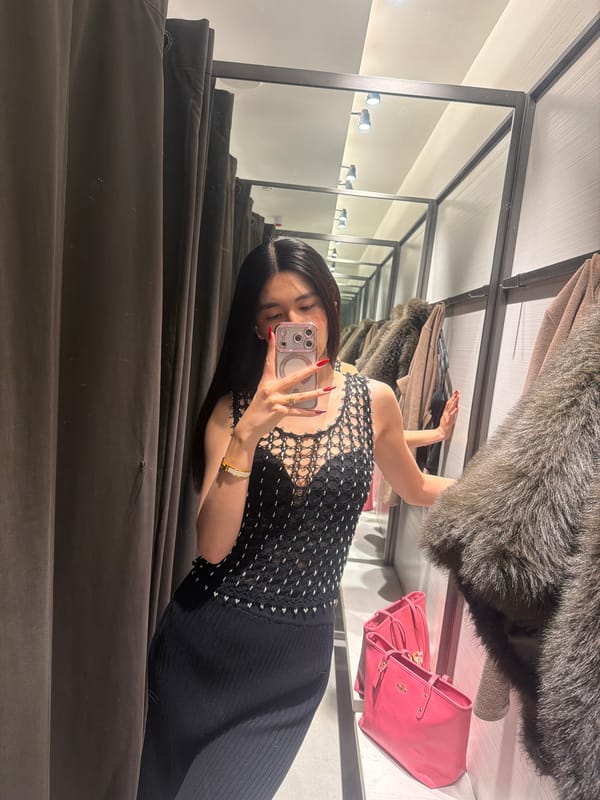 Woman takes selfie in Paris clothing store dressing room