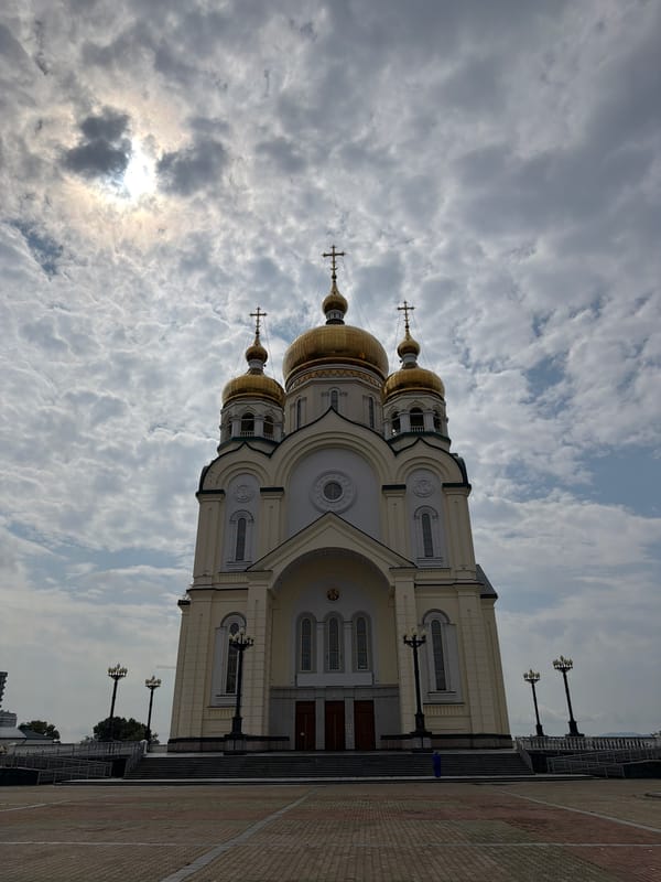 Khabarovsk's golden-domed cathedrals under a cloudy sky