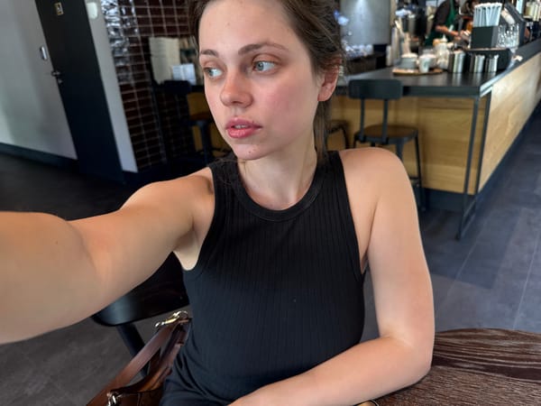 Woman takes selfie at Prague Starbucks café
