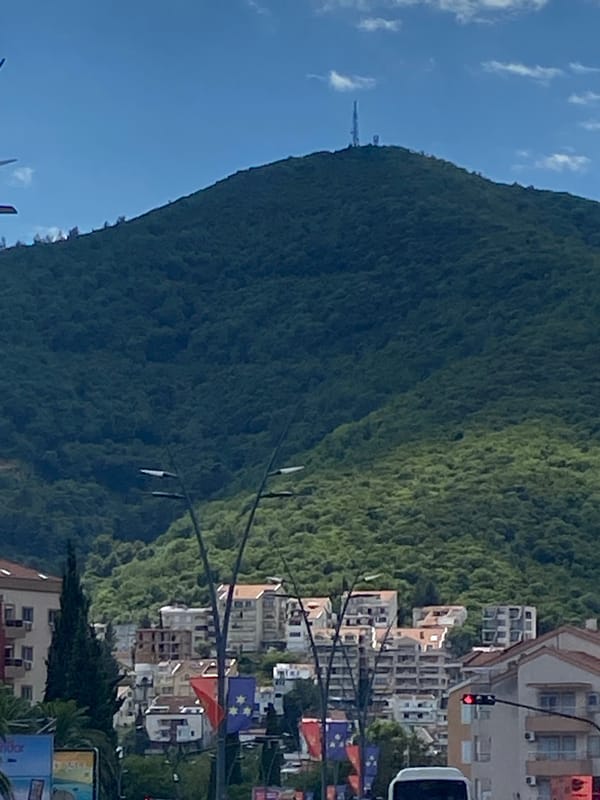 Budva's mountain skyline and modern architecture on a cloudy afternoon