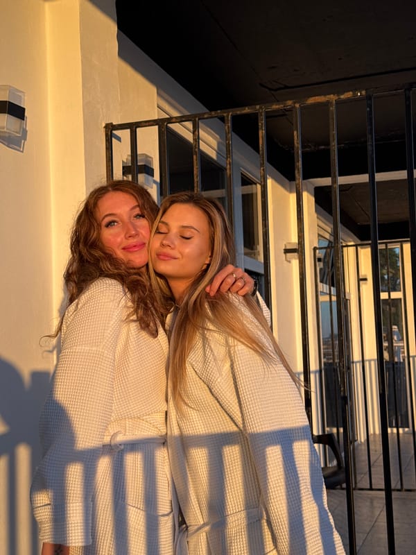 Two women share quiet moment in Sokhumi bathrobes