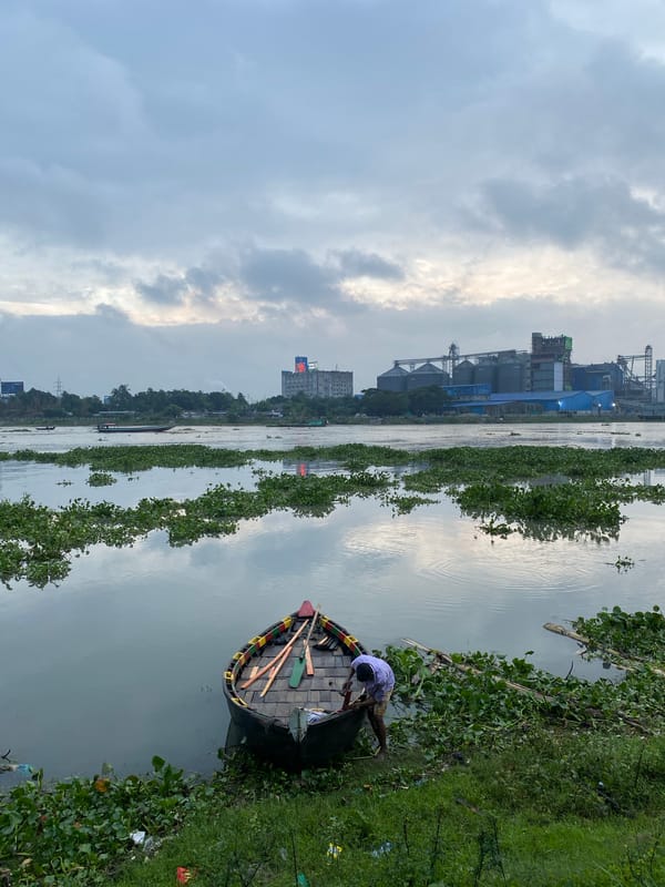 Buriganga River life: boats, flowers, and industrial infrastructure
