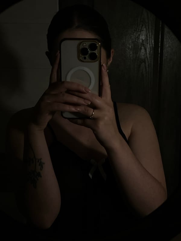 Person Takes Mirror Selfie with Gold-Cased Phone in Ternopil